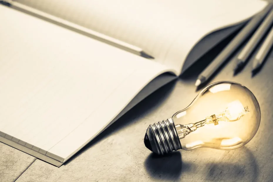 pencil paper and light bulb on desktop - courtesy of Andy Westwoods